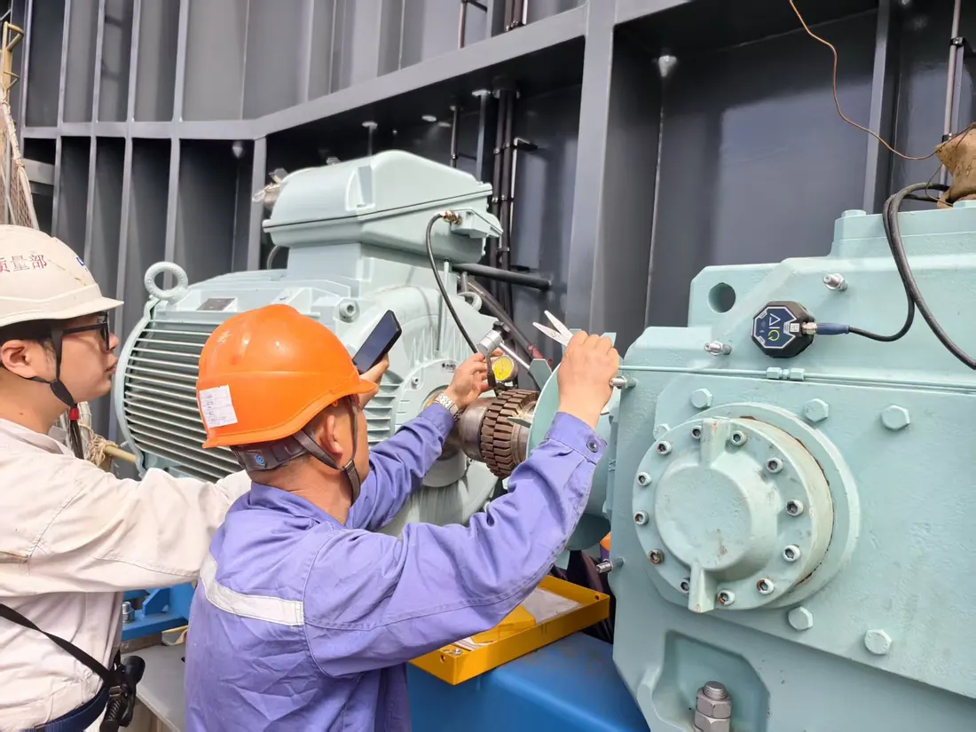 Marine professionals carrying out hands-on machinery inspection