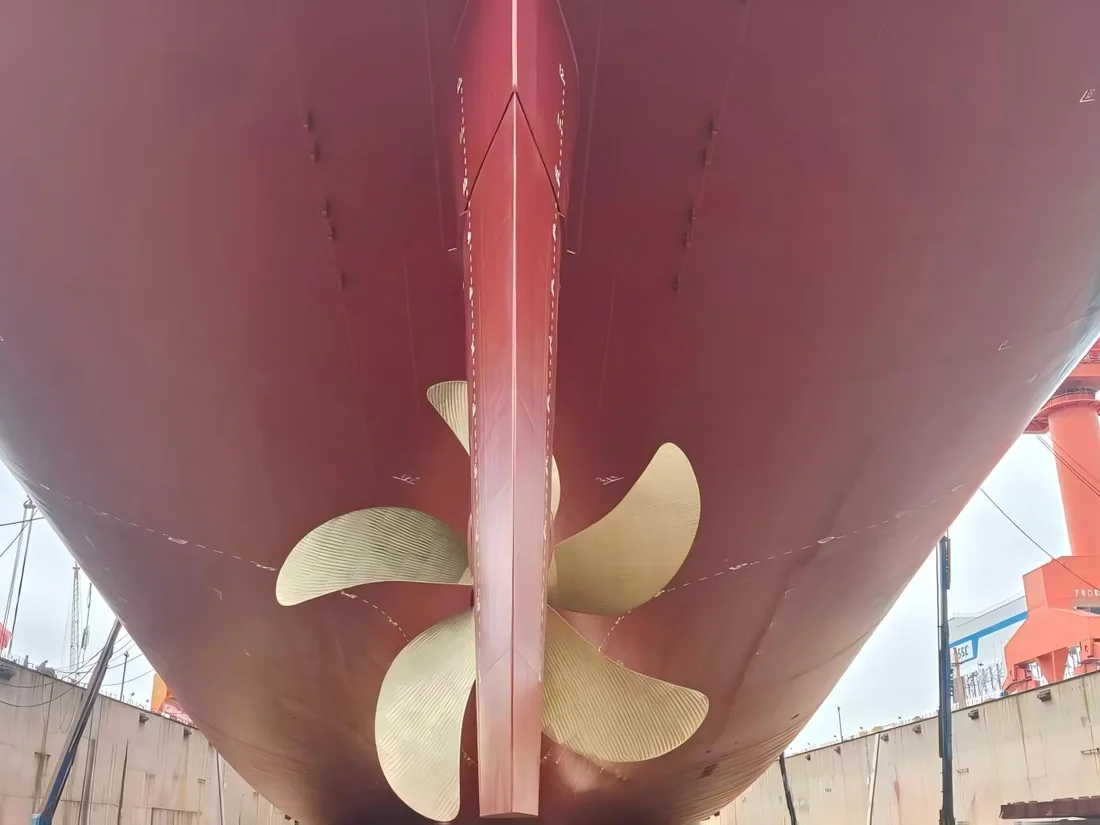 Twin-propeller commercial vessel stern in a shipyard dry dock