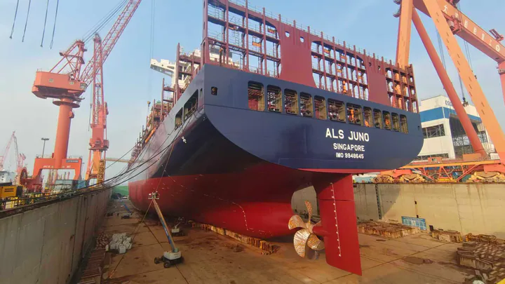 Large commercial vessel viewed from the stern quarter in drydock